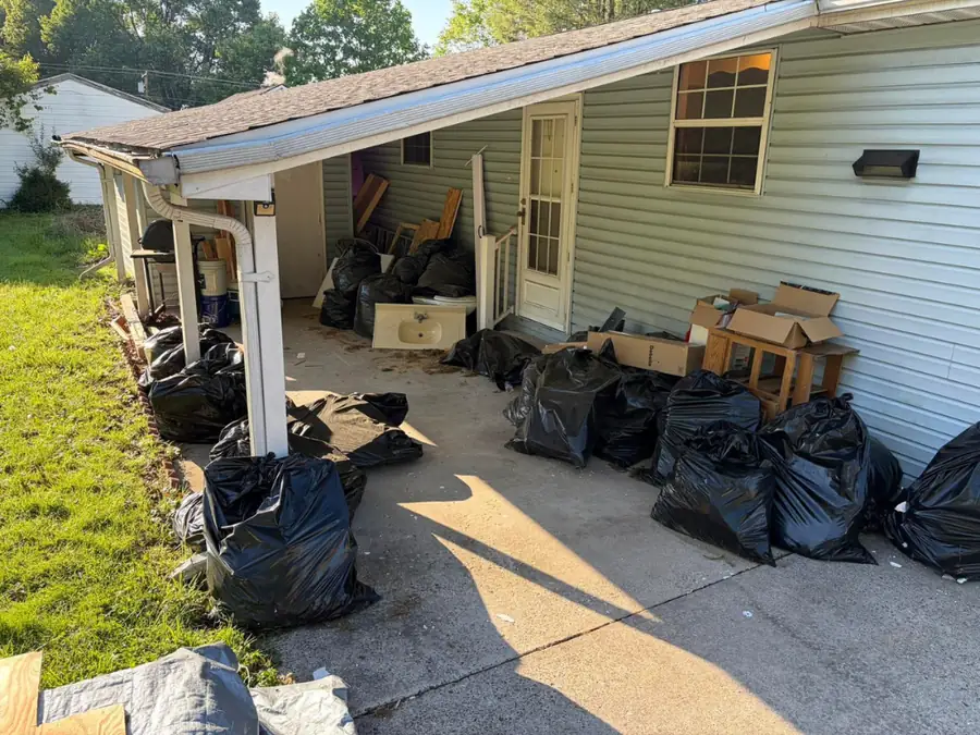 Dozens of filled black bags and boxes lined up outside a property ready for collection